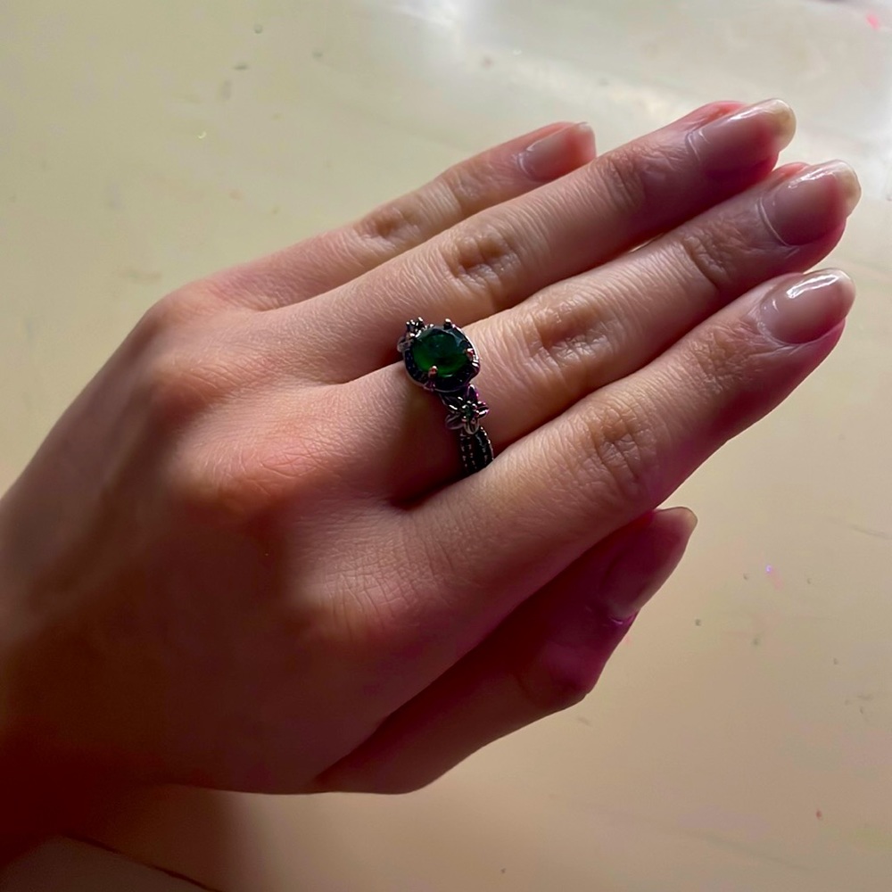 Emerald green and black ring